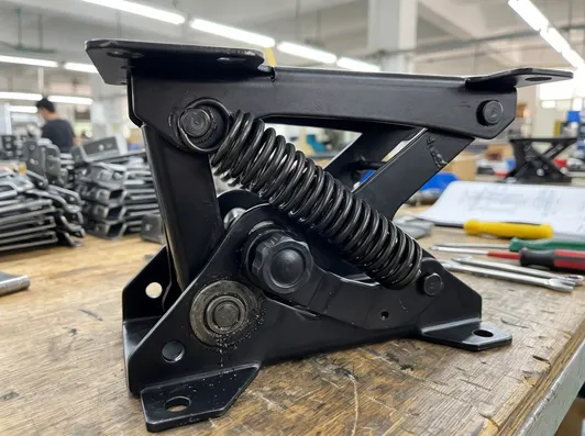 Close-up technical detail of automatic chair mechanism steel components and spring assembly