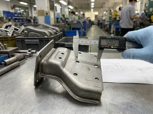 Stamped steel backrest bracket showing dimensional tolerance and mounting hole pattern