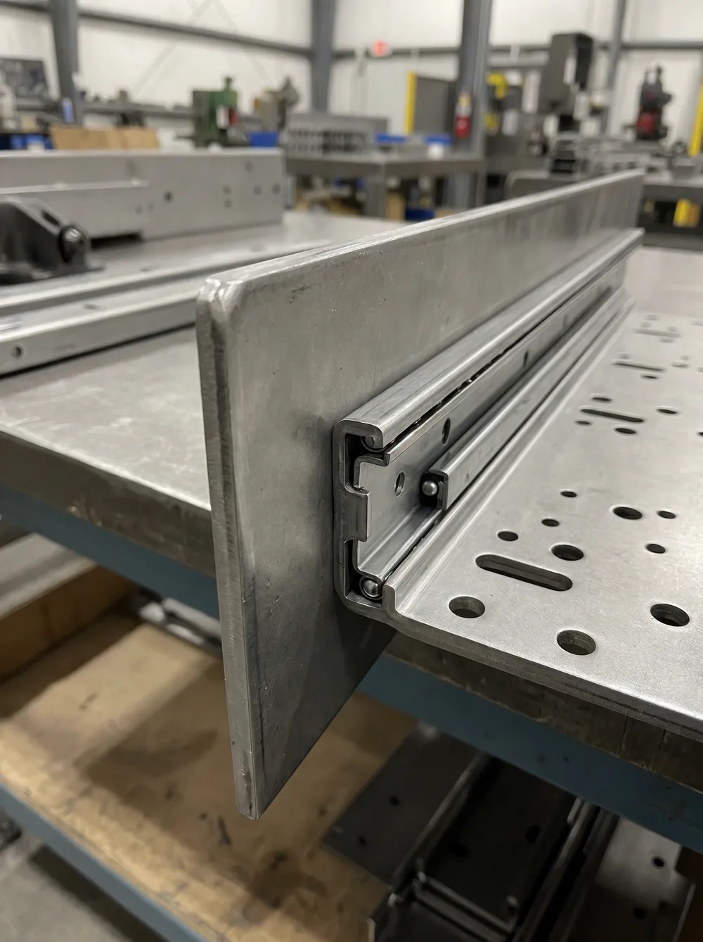 Sliding chair mechanism technical detail showing plate thickness, slide rail geometry, and mounting hole pattern