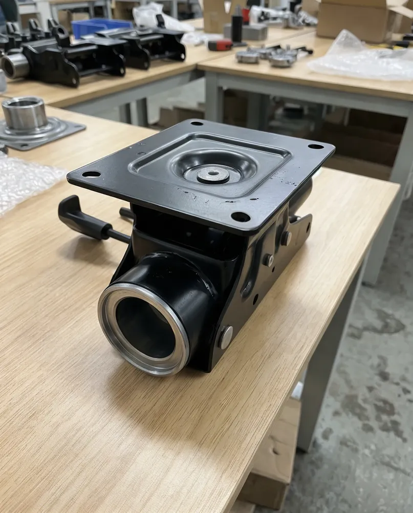 Swivel chair mechanism showing top plate mounting pattern and bottom bore gas lift interface