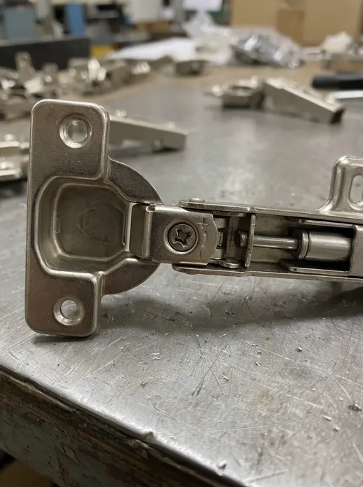 35mm cup bore hinge mechanism showing adjustment cam and soft-close damper detail