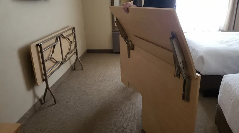 Hotel room fold-down desk and banquet folding table in commercial hospitality setting