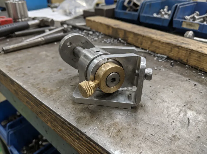 Precision rotation mechanism with friction joint for controlled angular positioning