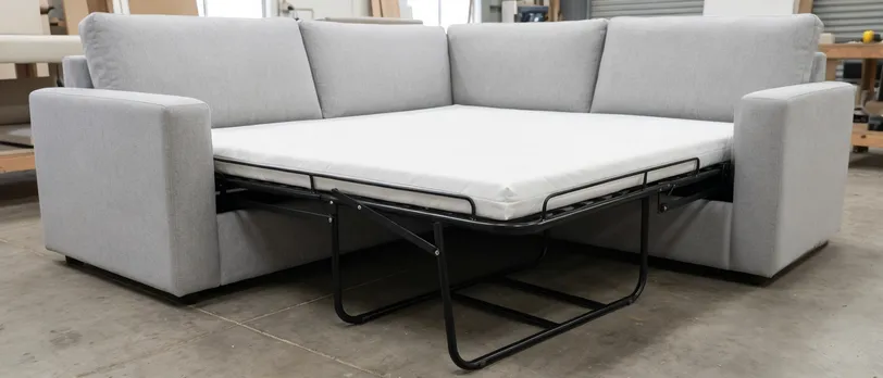 Sofa bed mechanism deployed showing full mattress platform on deep-seat sofa